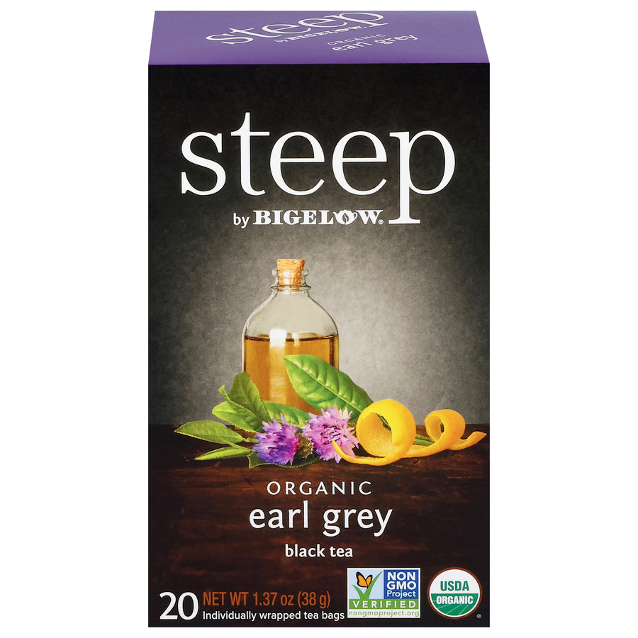 Box of steep by Bigelow Organic Earl Grey black tea with tea leaves and bottle on a dark background
