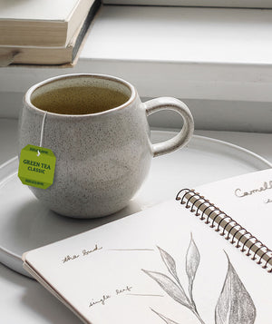 Bigelow Tea | Tea Education - green tea in cup with notebook - Mobile