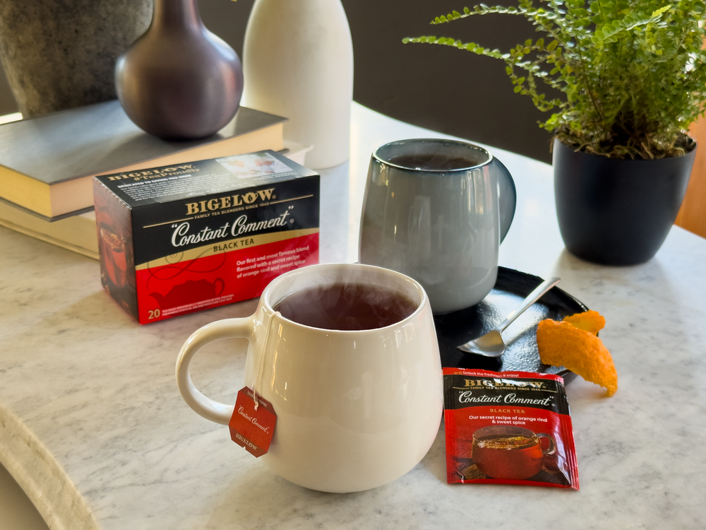 Box of  Constant Comment Tea with cup of tea and foil packet