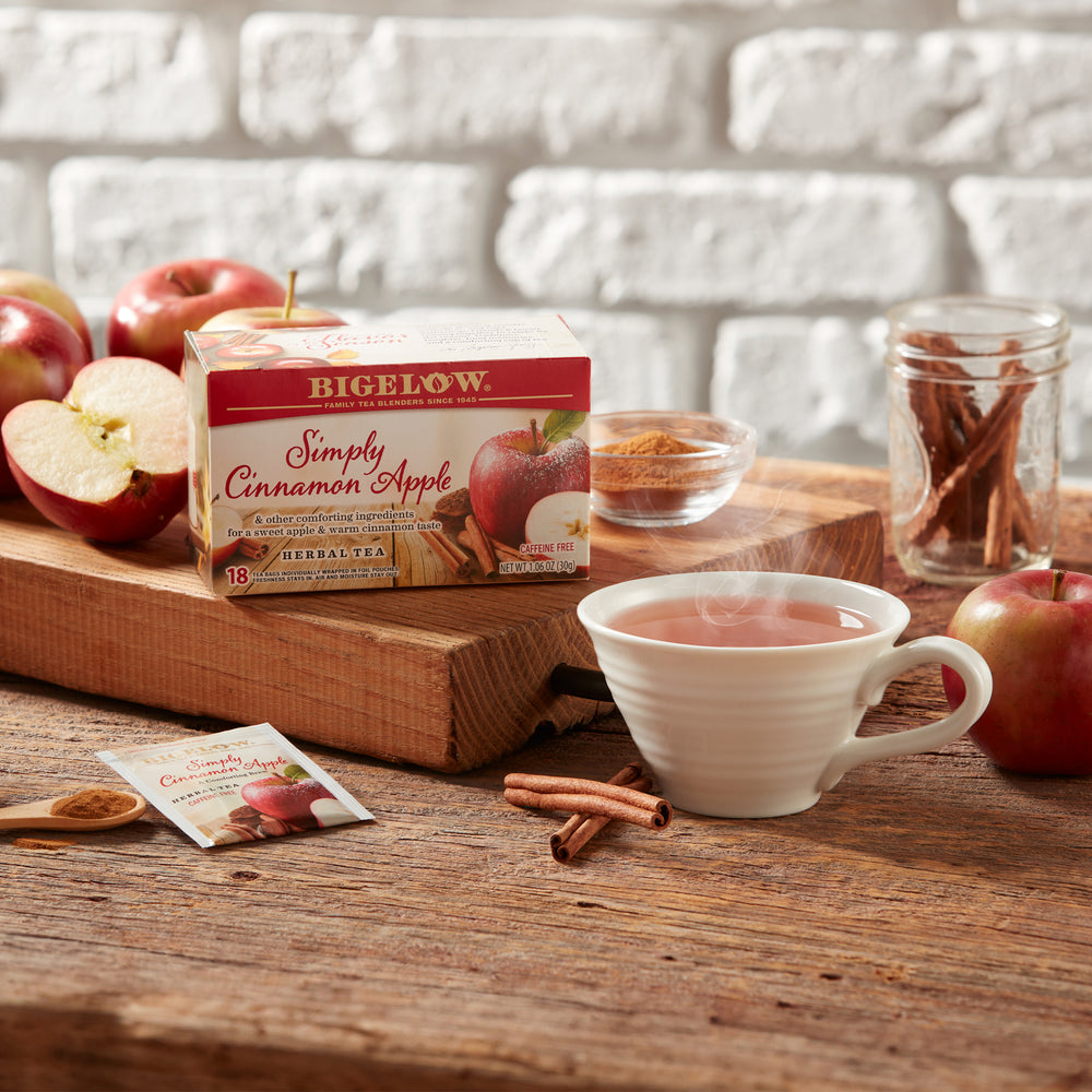 Mug of Simply Cinnamon Apple Herbal Tea with apples by the window