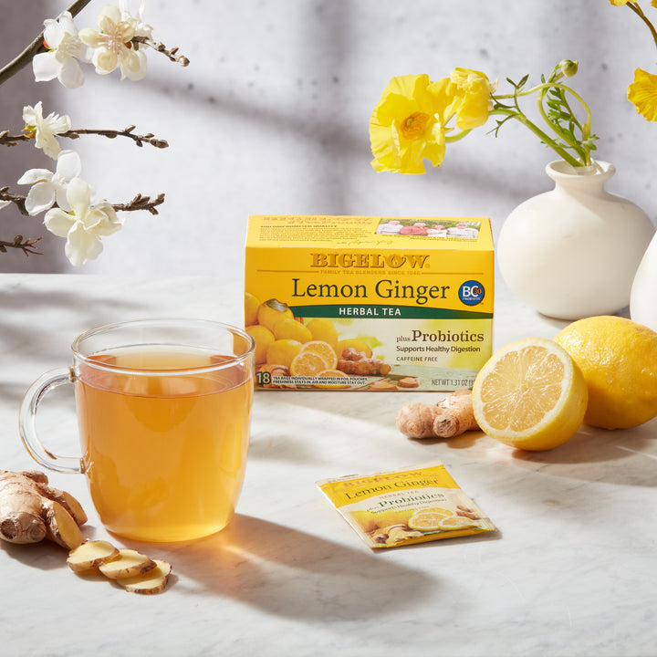 Mug of Lemon Ginger Plus Probiotics Herbal Tea on table with flowers