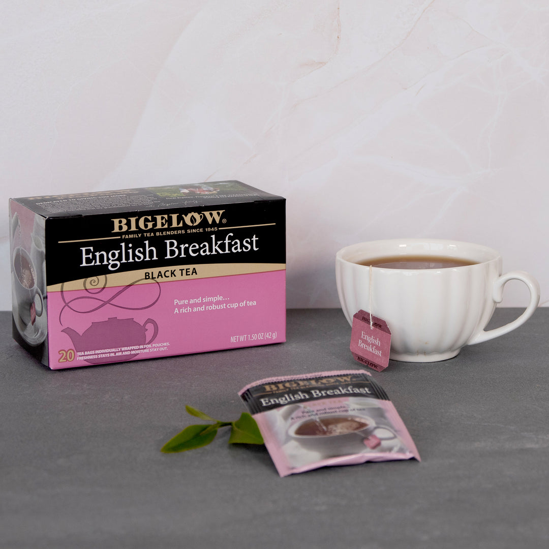 Bigelow English Breakfast tea packaging with a cup of tea on a gray surface.