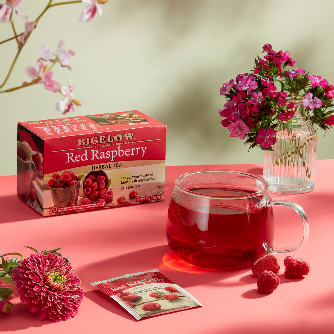 Mug of  Red Raspberry Herbal Tea with box and flowers
