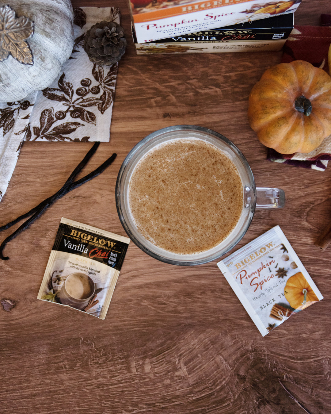 Bigelow Vanilla Chai and Pumpkin Spice foil packets with mug of latte