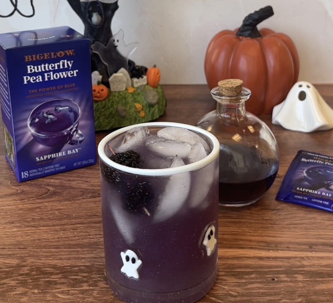 Bigelow Butterfly Pea Flower Sapphire Bay Tea Box in Halloween Setting with glass cup of blue tea mocktail