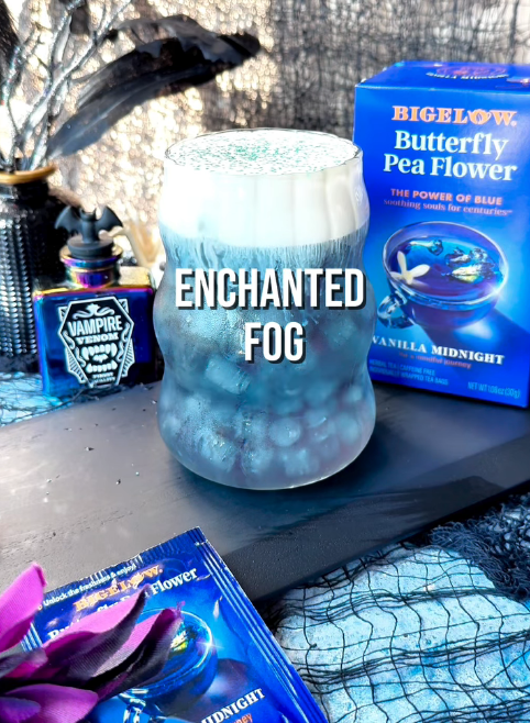 Bigelow Butterfly Pea Flower Vanilla Midnight Herbal Tea with glass labeled Enchanted Fog