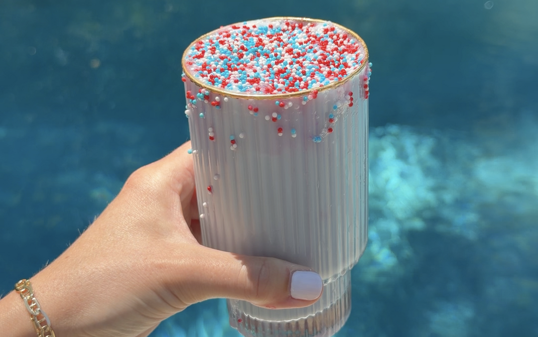 Blue Tea Dot Latte with sprinkles with pool water background