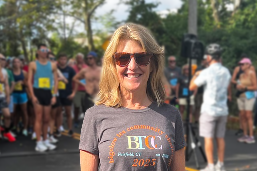 Cindi Bigelow standing in front of the racer for the Bigelow Tea Community Challenge