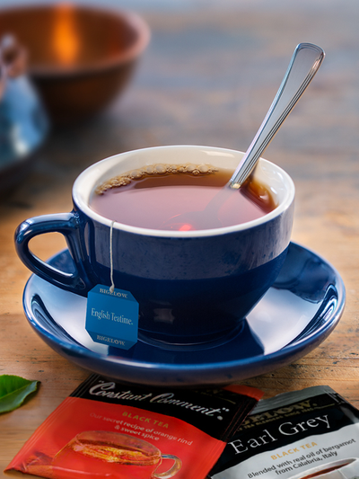 A cup of Bigelow Constant Comment tea in a blue cup