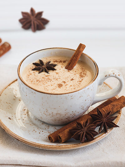 Bigelow Tea | Chai Tea - Cup of tea on a table with ingredients