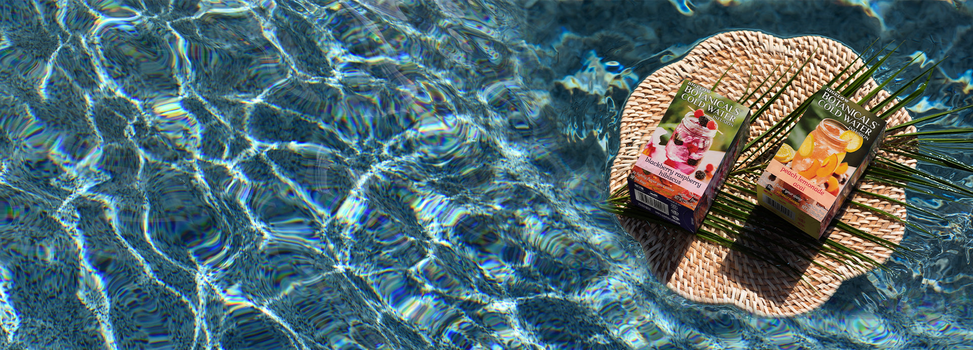 Bigelow Botanicals Cold Water Infusions laying on woven mat in pool 