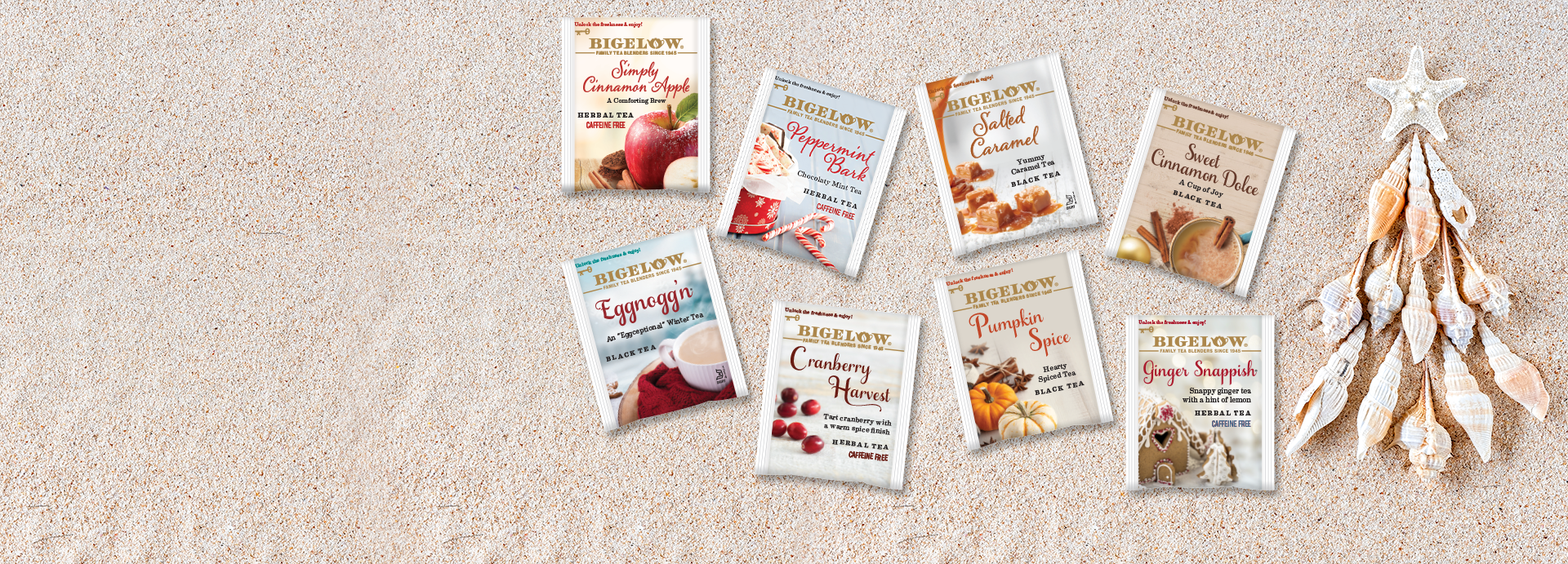 Sand background with 8 seasonal tea overwrap tea bags with seashell tree