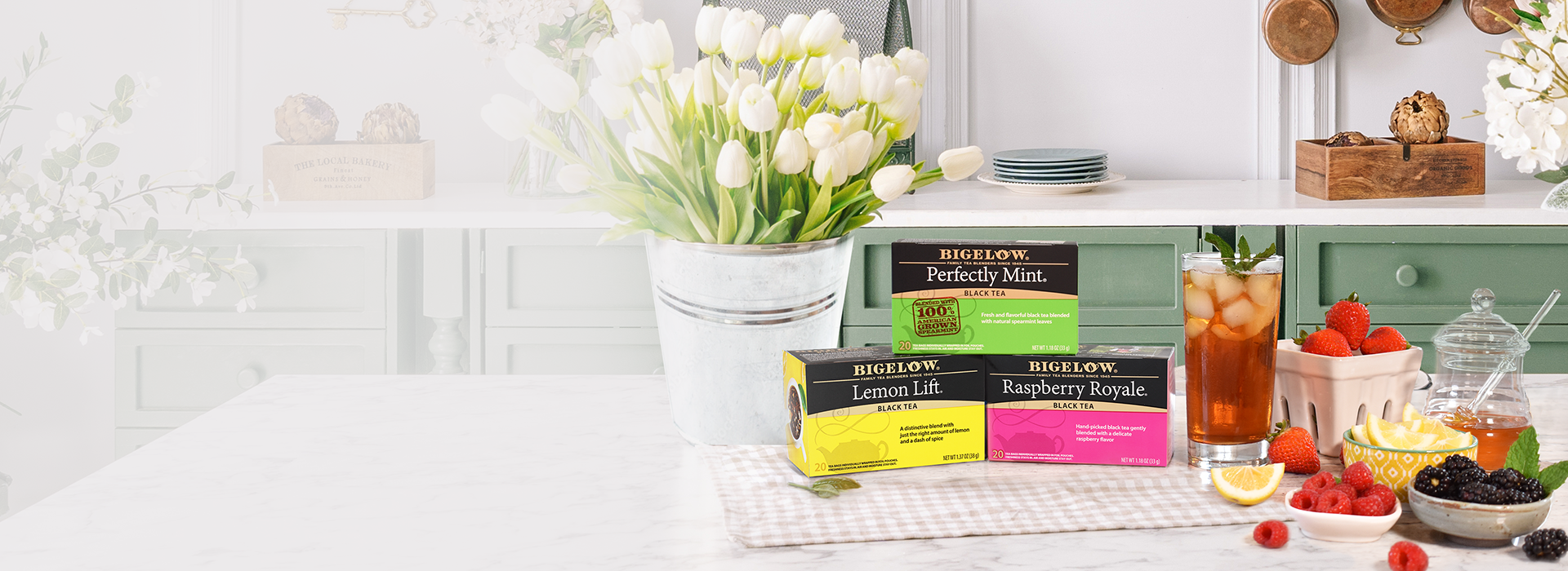 Boulevard Tea Company tea packages on a kitchen counter with flowers and snacks.