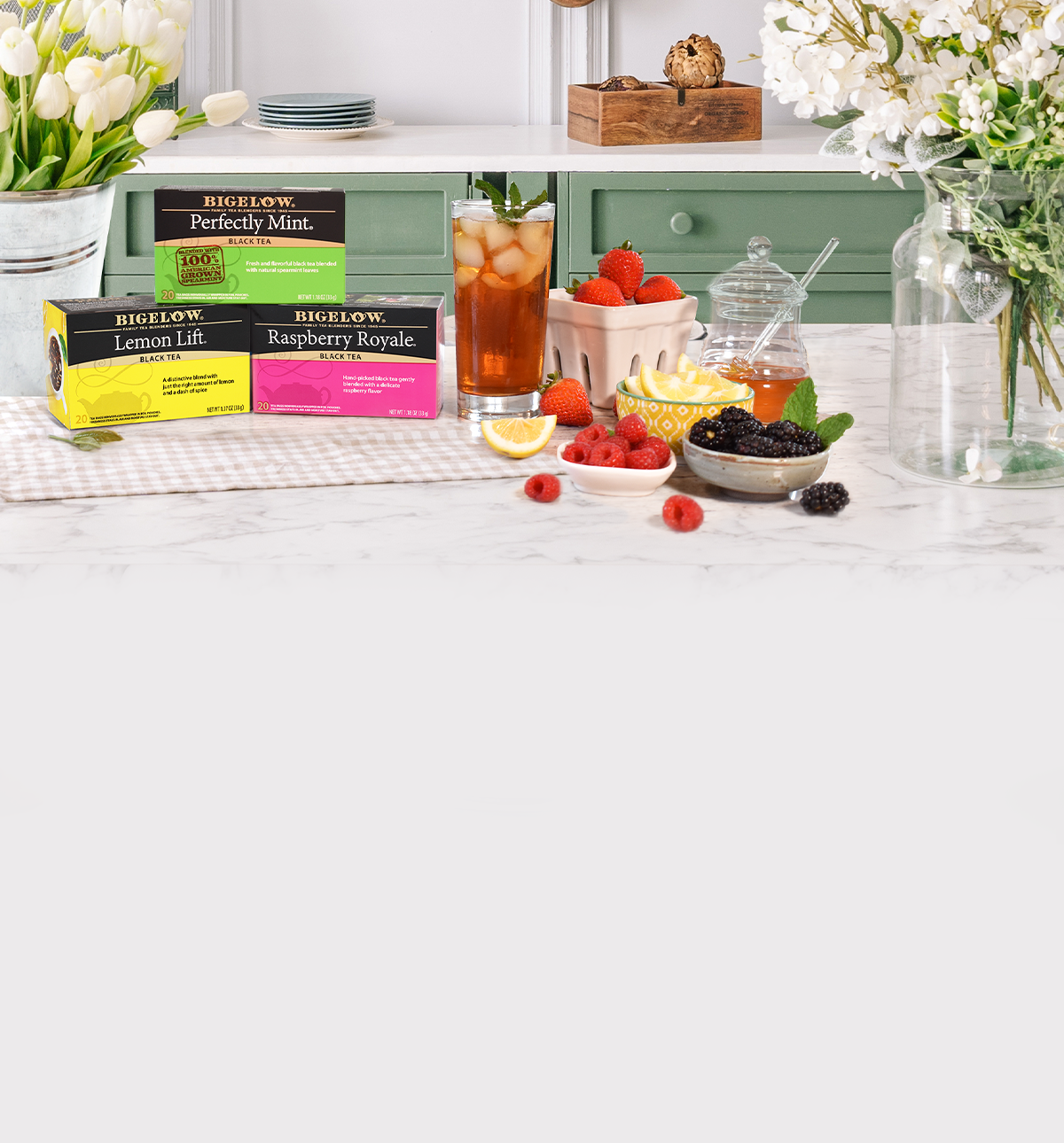 Tea packaging on a table with a fruit and tea set