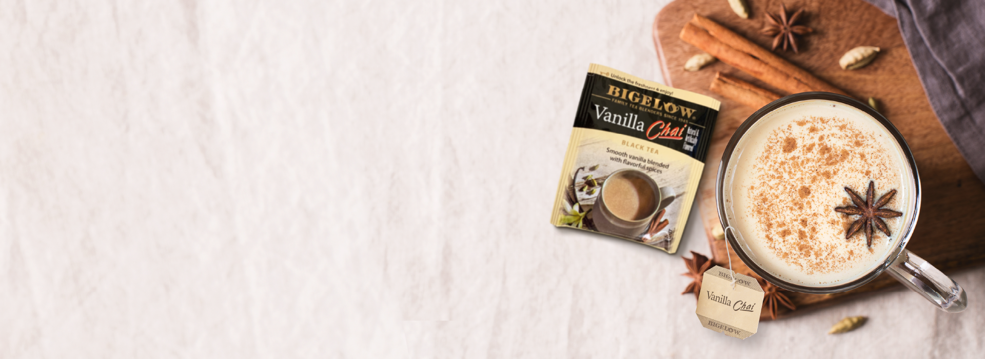 Vanilla Chai foil packet with mug of chai tea on white background
