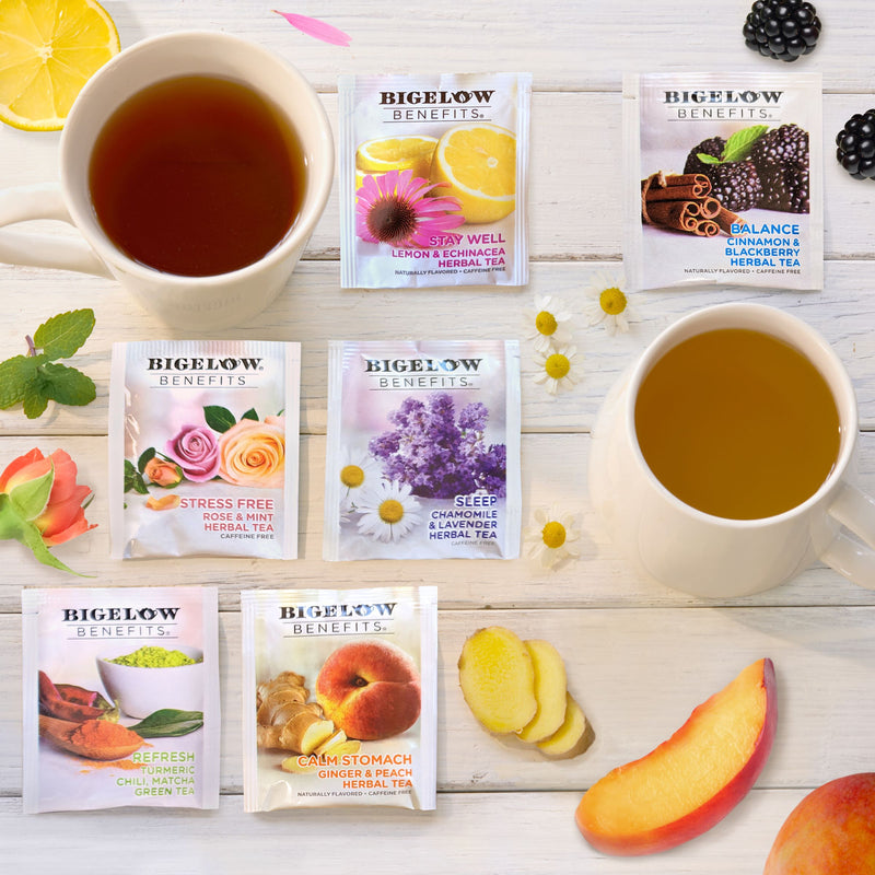 Cups of Bigelow Benefits Herbal and Green Tea boxes with ingredients