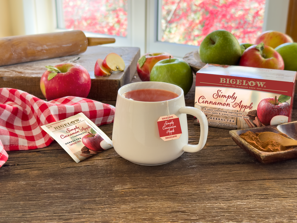 Mug of Simply Cinnamon Apple Herbal Tea with apples by the window