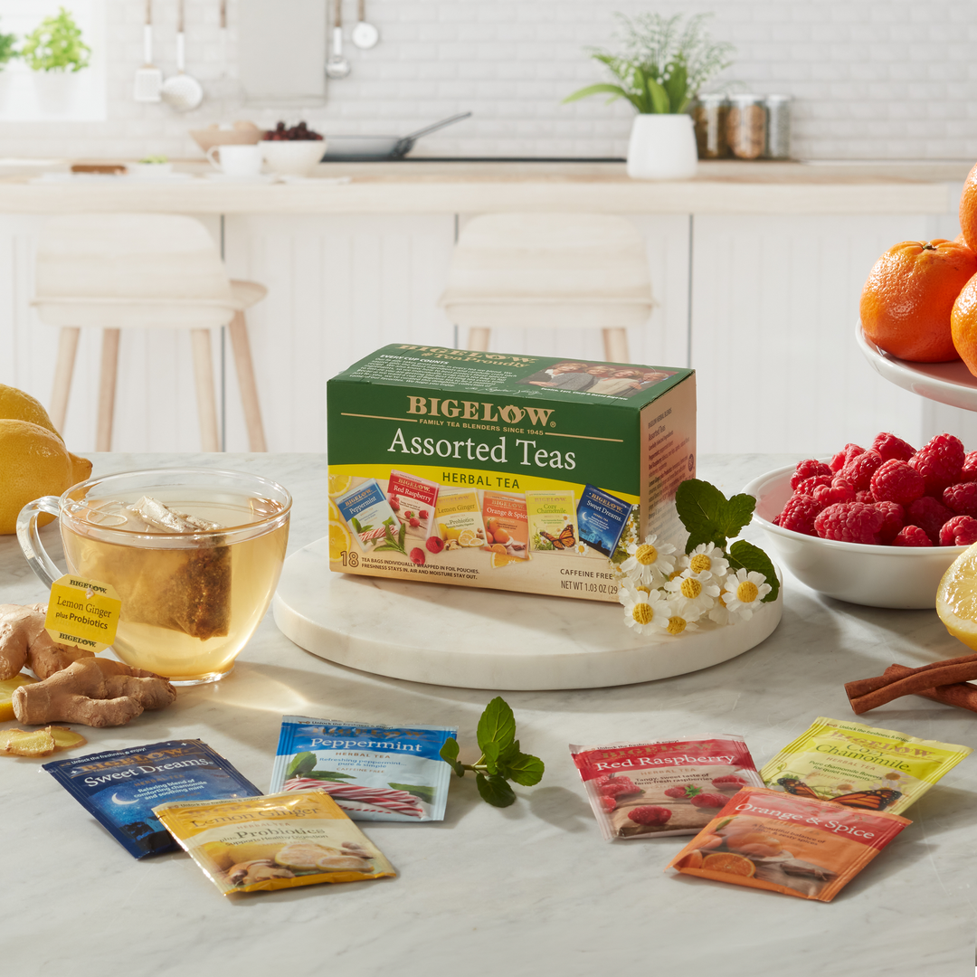 Box of Assorted Herbal Teas with foil packets with fruit and spices on a kitchen counter