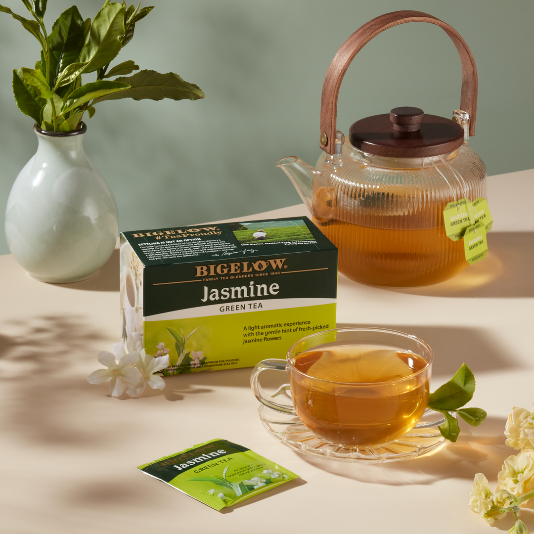 Cup and teapot of Jasmine Green Tea on a table