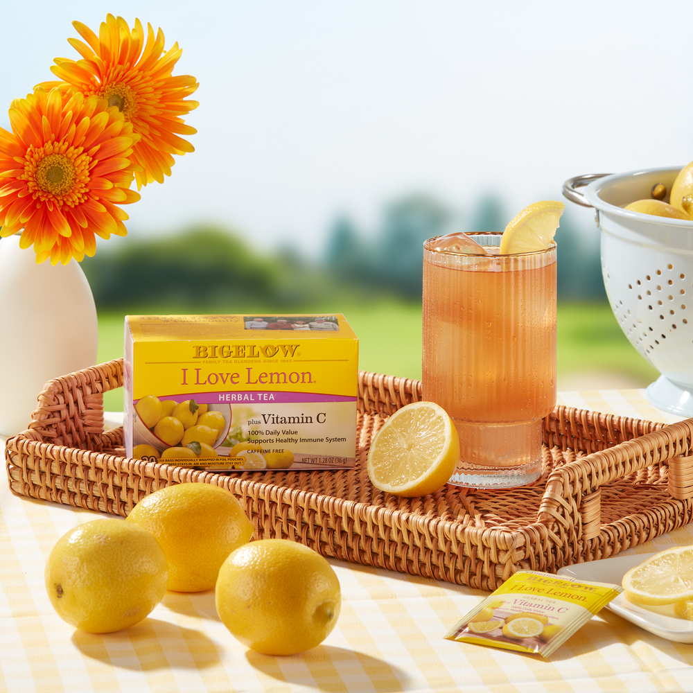 Glass  of I Love Lemon with Vitamin C iced with box, foil on wicker tray in outdoor setting
