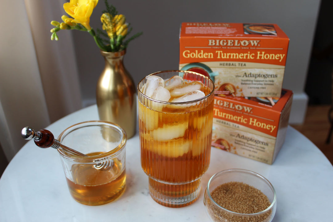 Glass of Bigelow Golden Turmeric Honey Herbal Iced Tea on a tray