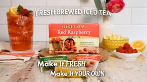 Fresh Brewed Iced Tea text against tile background with glass of pink drink and box of Bigelow Red Raspberry tea