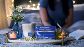 screenshot of Sweet Dreams video with box of Bigelow Sweet Dreams tea on marble table with cancles