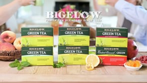 Screenshot of 6 Bigelow Green Tea boxes in assorted flavors on wood counter with fruit -video should play