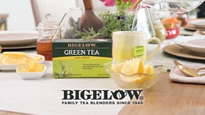 Bigelow Green Tea with Lemon box on dinner table with lemons and honey