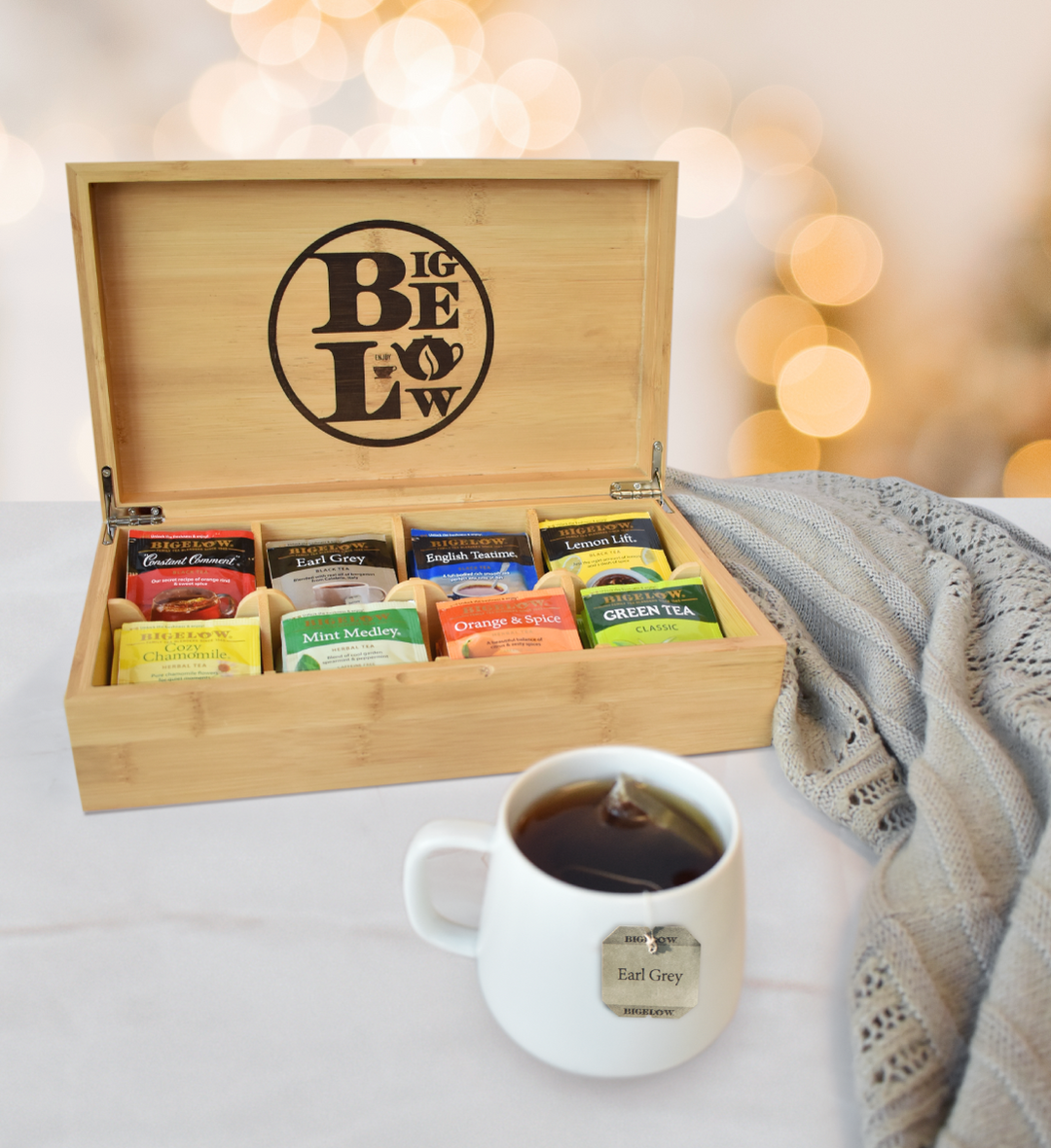 Bigelow Wooden Tea Chest with Logo featuring 8 flavors of teas with white mug of tea